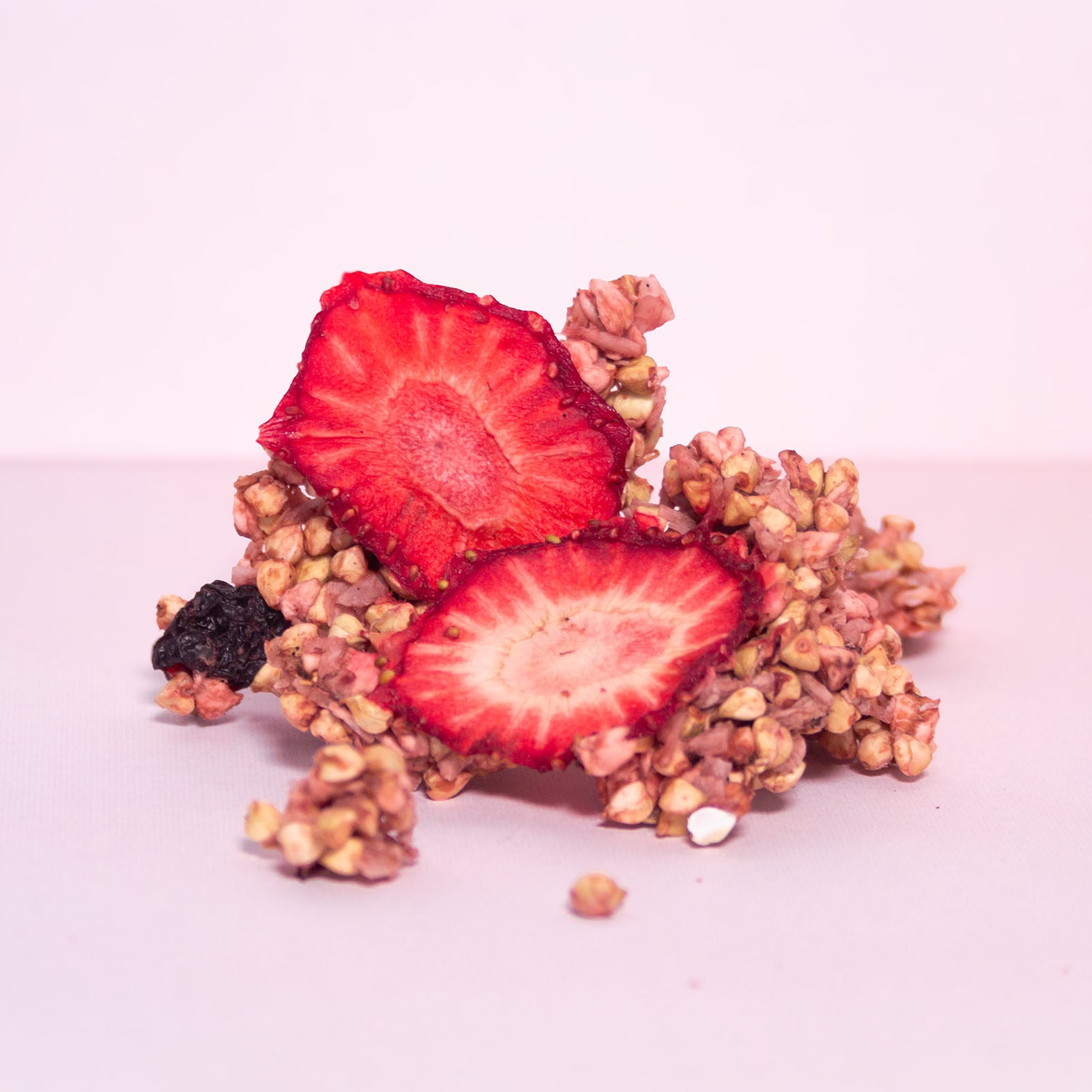 Ein unverpacktes Stück vom Erdbeer-Kirsch Granola mit luftgetrockneten Erdbeeren und gekeimten Buchweizen